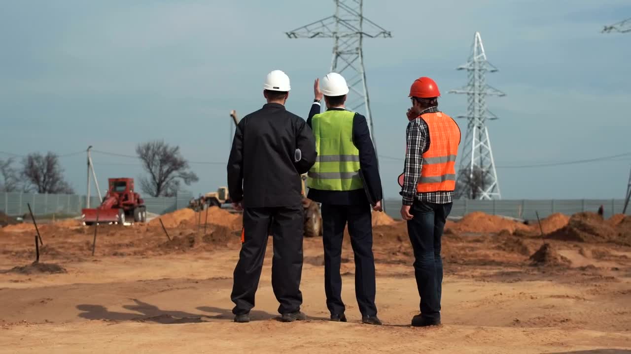 Stock Video Engineers Talking In Front Of The Electrical Towers Live Wallpaper For PC