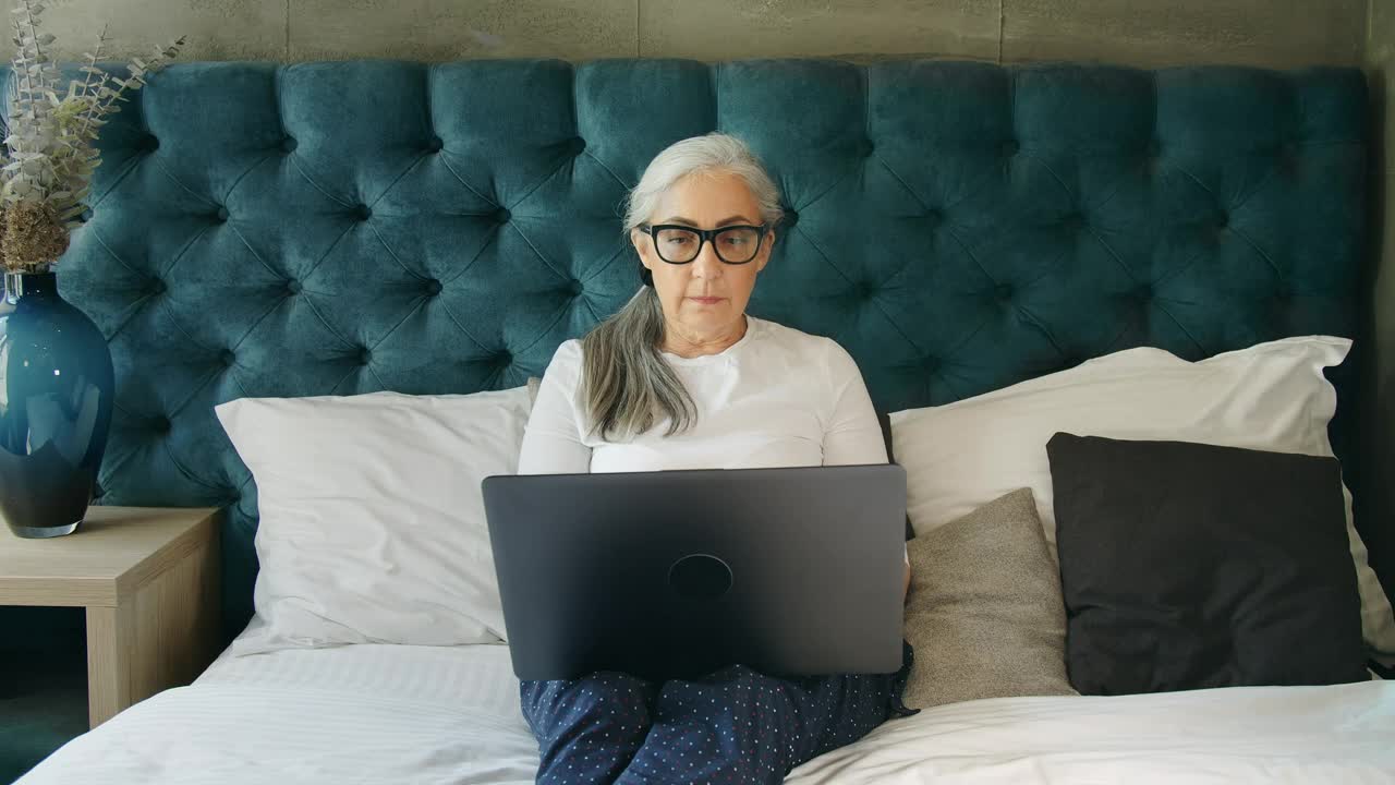 Stock Video Elderly Woman On Laptop In Blue Bedroom Live Wallpaper For PC