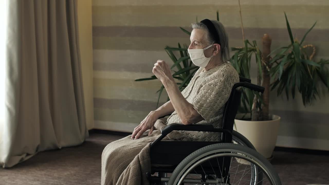 Stock Video Elderly Woman In A Wheelchair Wearing Mask Live Wallpaper For PC