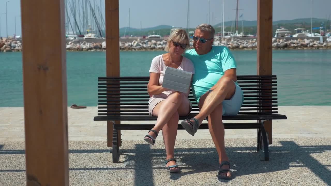 Stock Video Elderly Couple Using A Tablet By A Harbor Live Wallpaper For PC