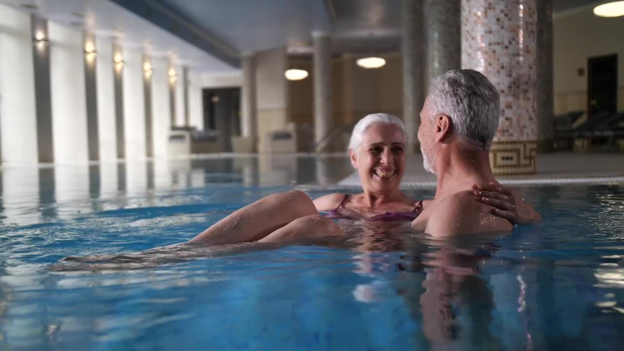 Stock Video Elderly Couple Enjoying Time In The Pool Live Wallpaper For PC