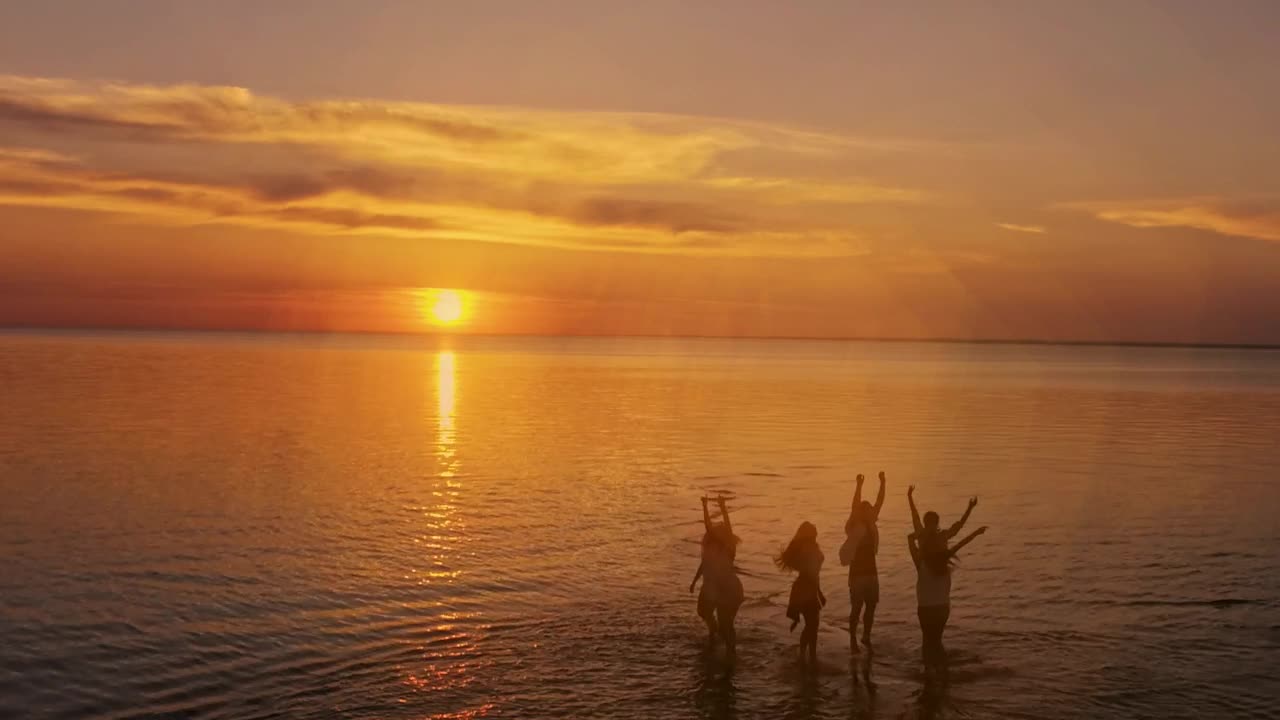 Stock Video Dreamy Sunset View Of People Jumping On Sea Surface Live Wallpaper For PC