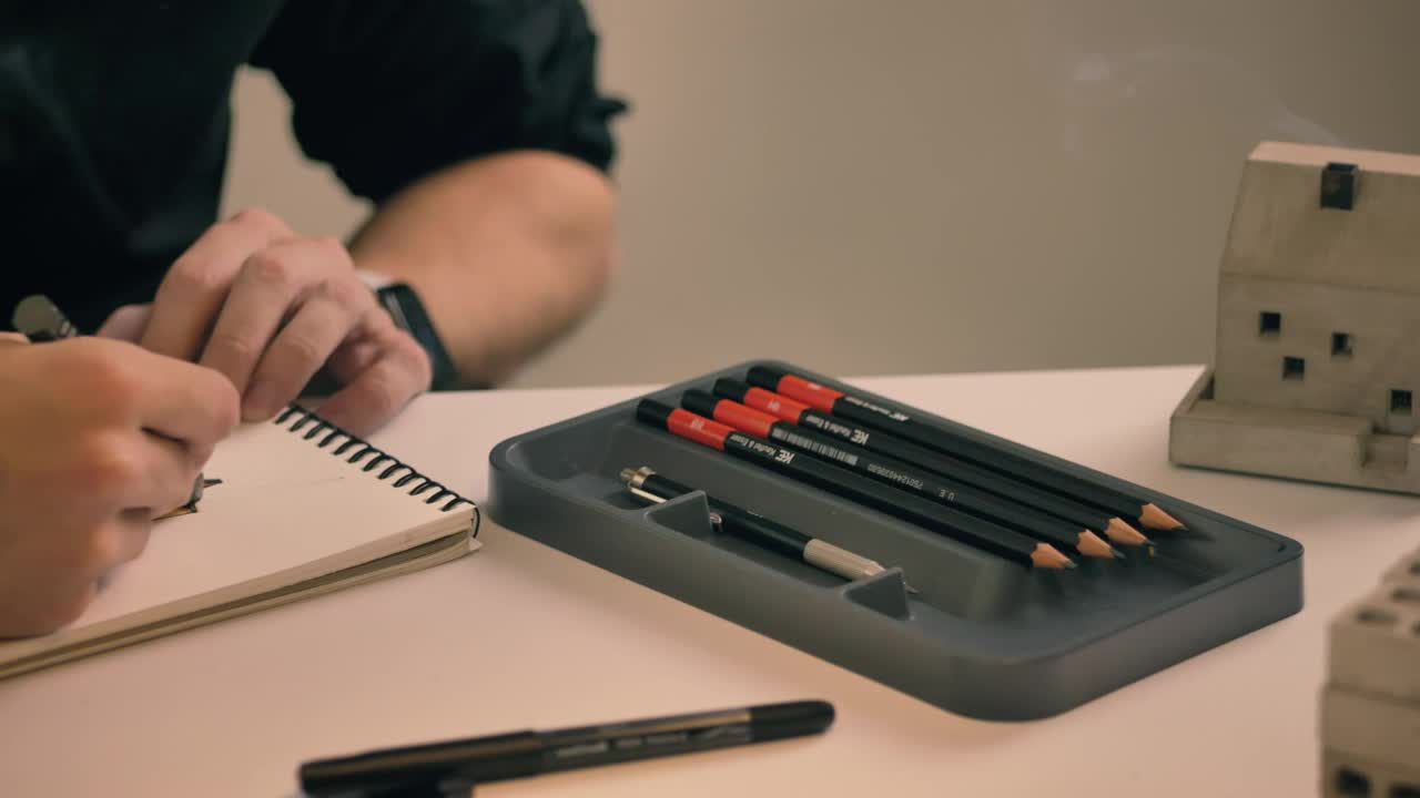 Stock Video Drawing In A Notebook On A White Table Live Wallpaper For PC