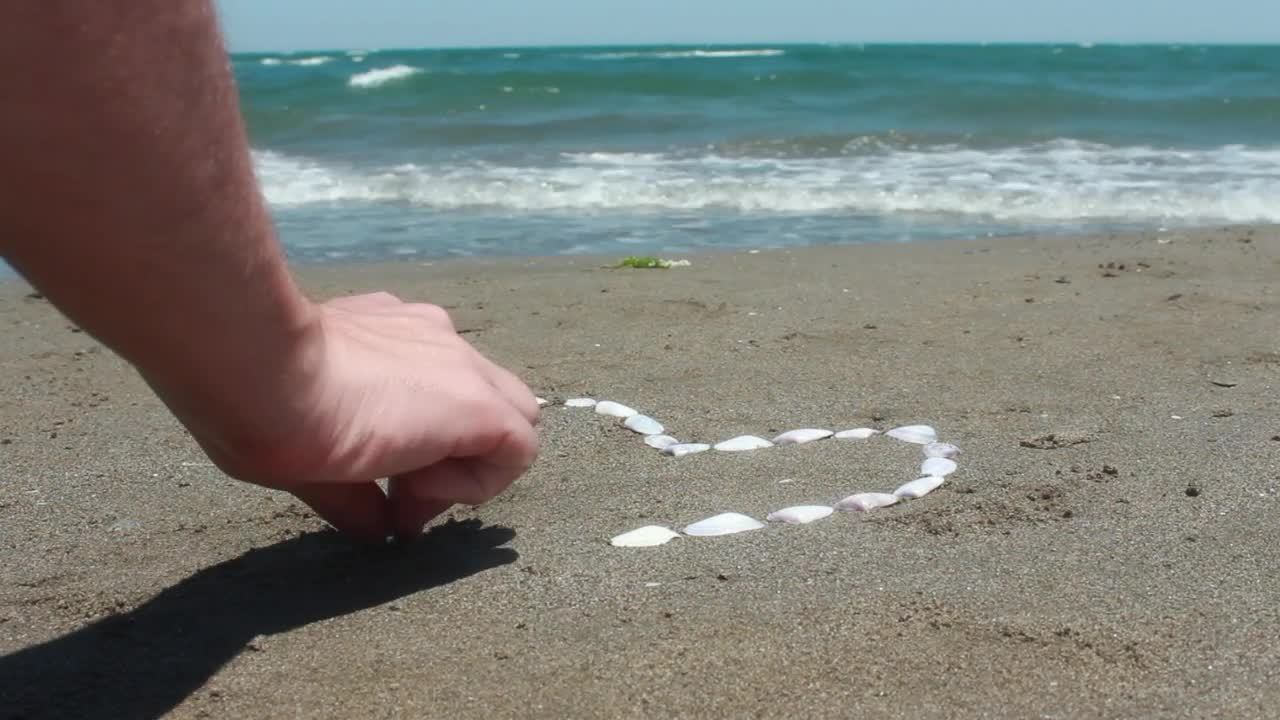 Stock Video Drawing A Heart On The Beach Using Oysters Live Wallpaper For PC