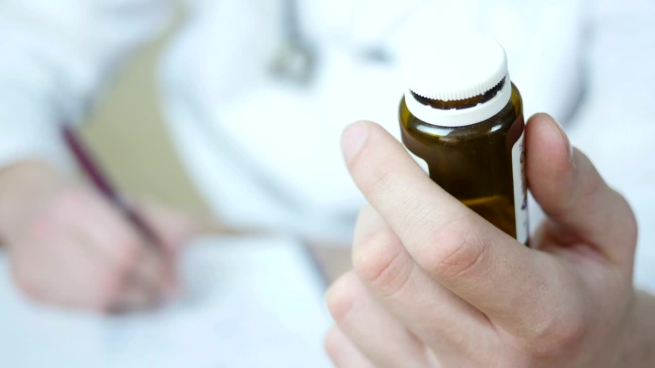 Stock Video Doctor Writing A Prescription Holding A Bottle Of Pills Live Wallpaper For PC
