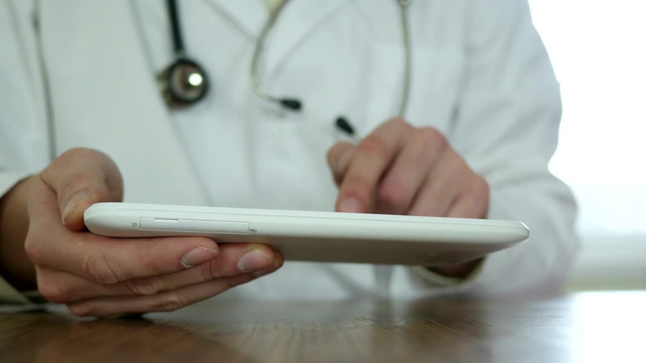 Stock Video Doctor With Gown And Stethoscope Typing On A Tablet Live Wallpaper For PC