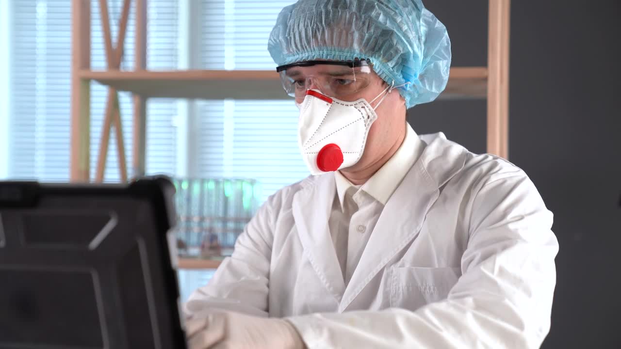 Stock Video Doctor Using A Facemask Typing On A Computer Live Wallpaper For PC