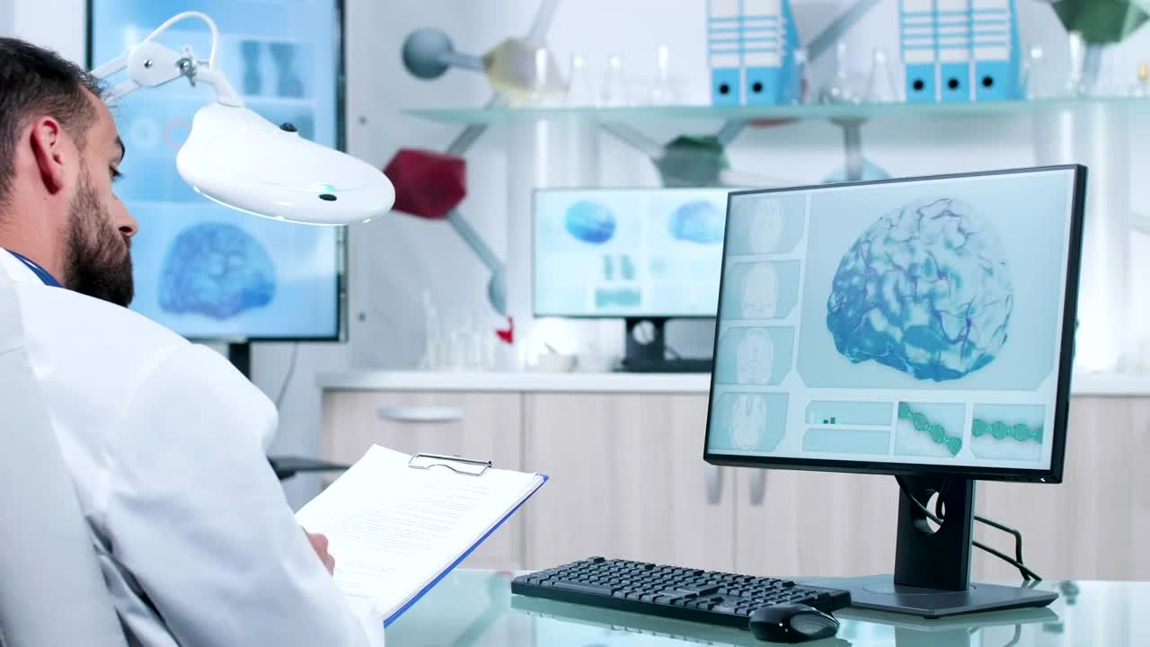 Stock Video Doctor Takes Notes While Reviewing Dna And Brain Models Live Wallpaper For PC