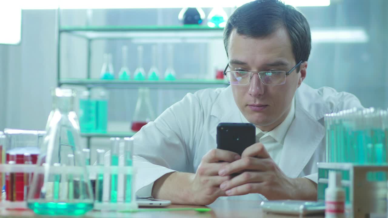 Stock Video Doctor In The Lab Looking At His Phone Live Wallpaper For PC