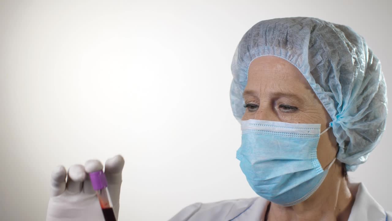 Stock Video Doctor Examining A Blood Test Wearing Mask Live Wallpaper For PC