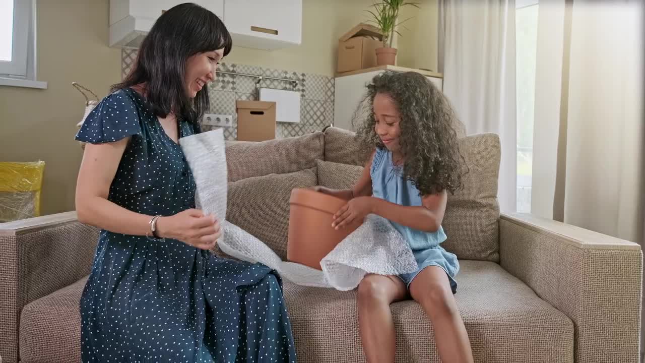 Stock Video Diverse Mom And Daughter Play On Sofa In New Home Live Wallpaper For PC