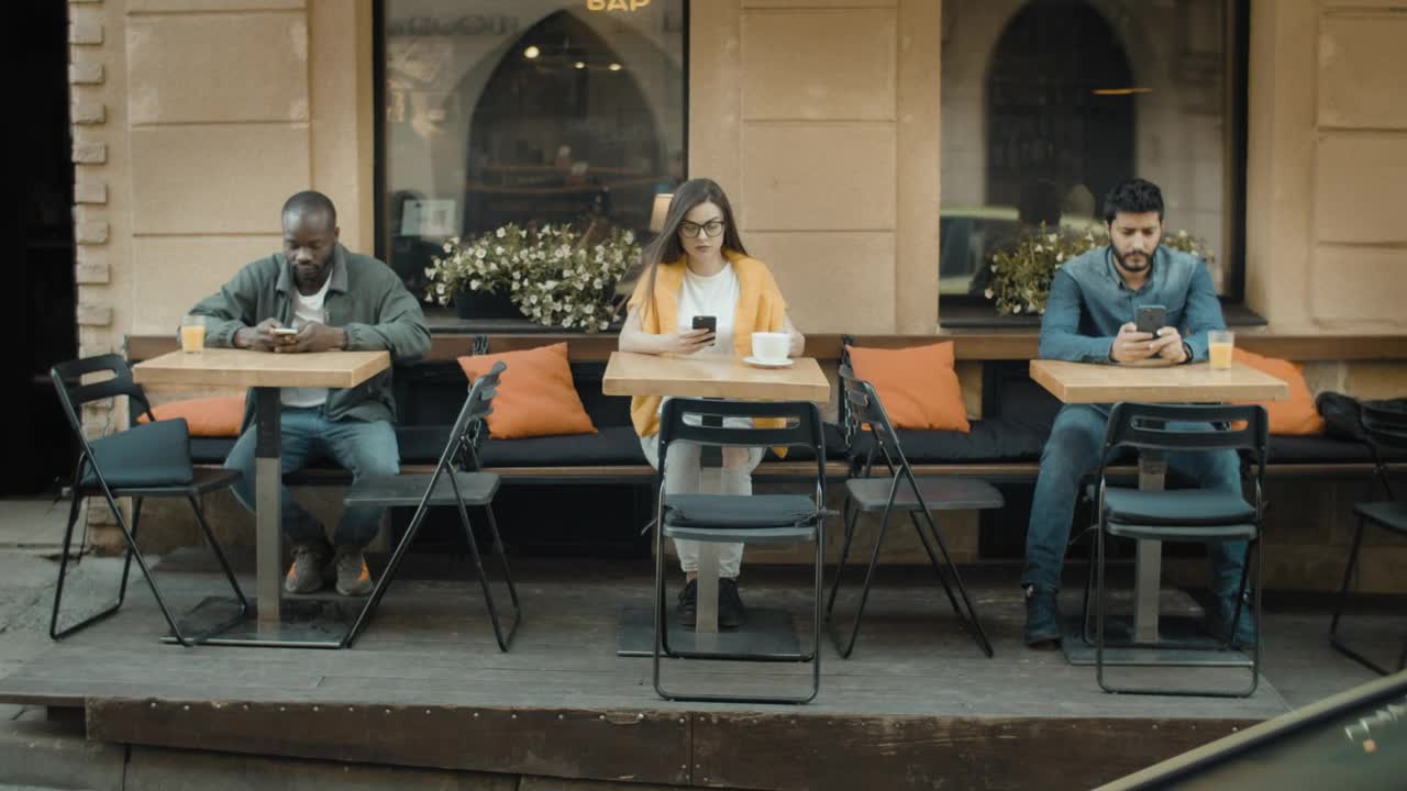 Stock Video Diverse Millenials Using Mobiles And Social Distancing In Cafe Live Wallpaper For PC