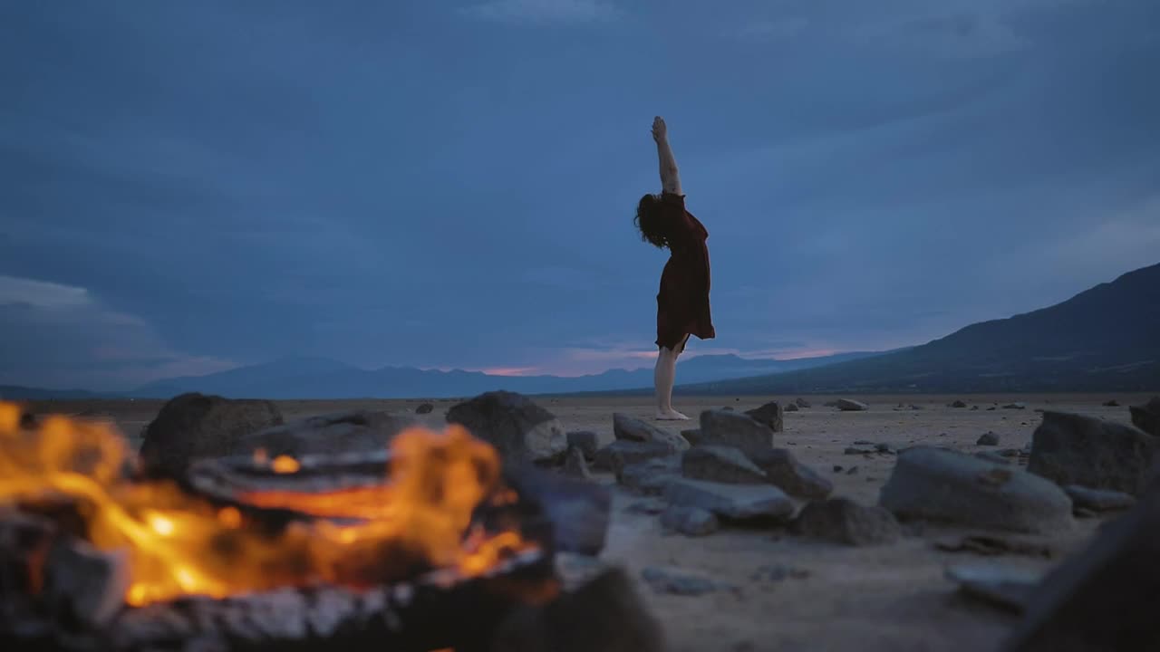 Stock Video Deserted Plain With A Campfire And A Woman Practicing Yoga Live Wallpaper For PC