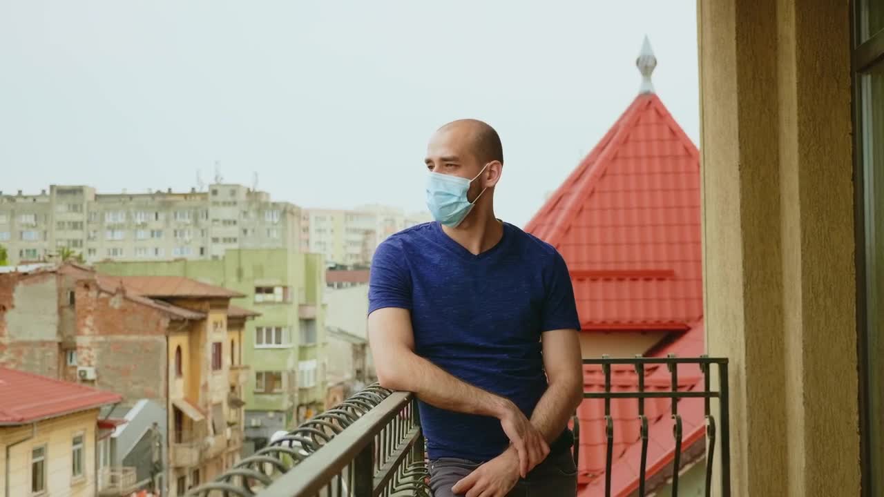 Stock Video Depressed Man Stands On Balcony In Face Mask Live Wallpaper For PC