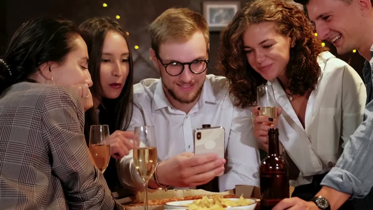 Stock Video Friends Celebrating A Special Date Look At A Cell Phone Live Wallpaper For PC
