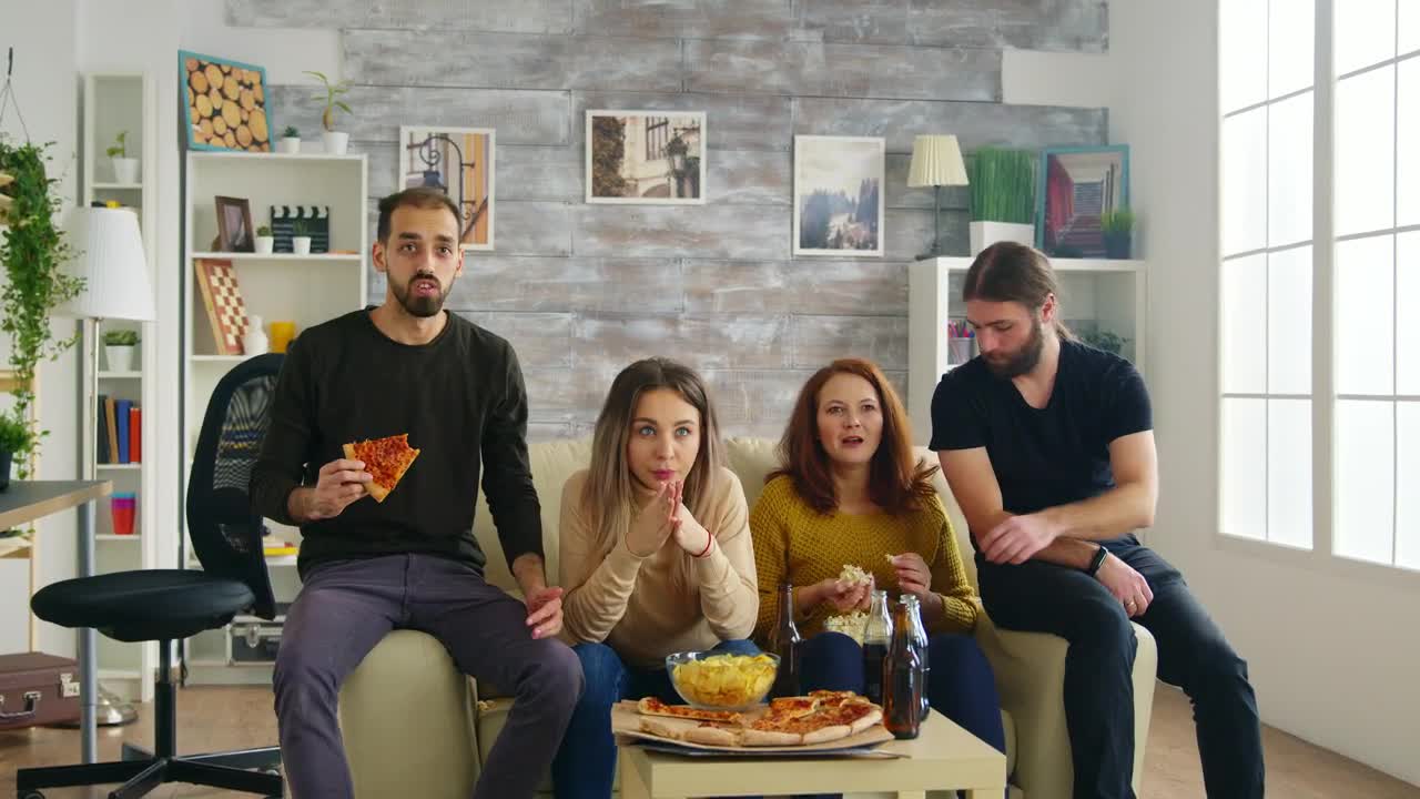 Stock Video Friends Celebrate Sports Victory On Sofa With Pizza Live Wallpaper For PC