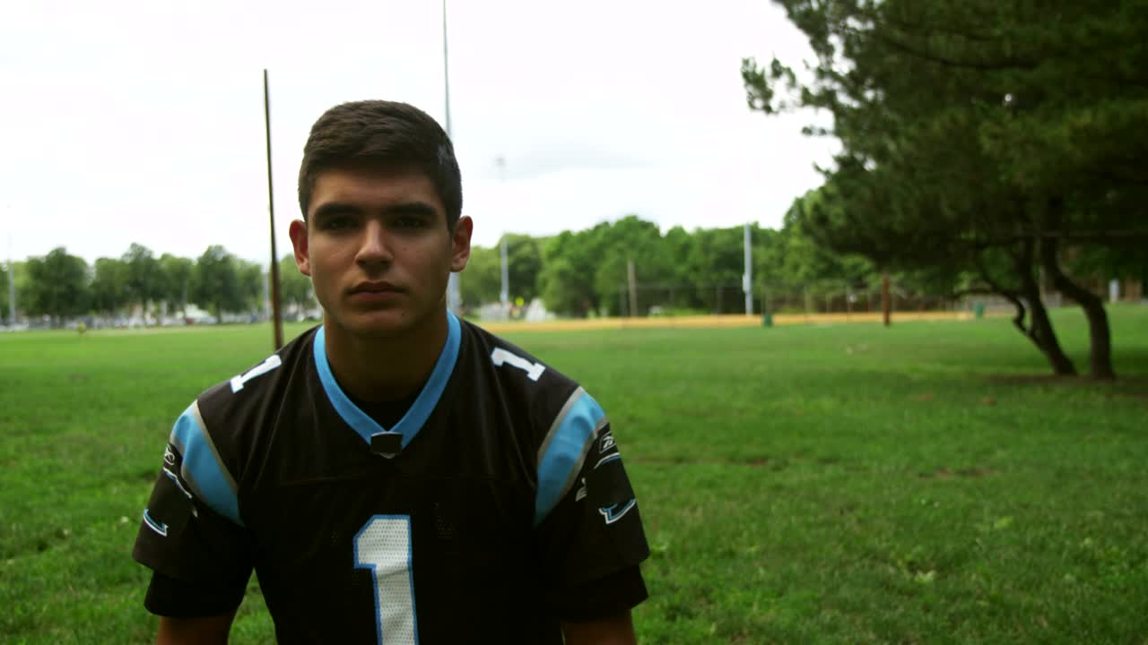 Stock Video Football Player Putting On A Blue Helmet Live Wallpaper For PC