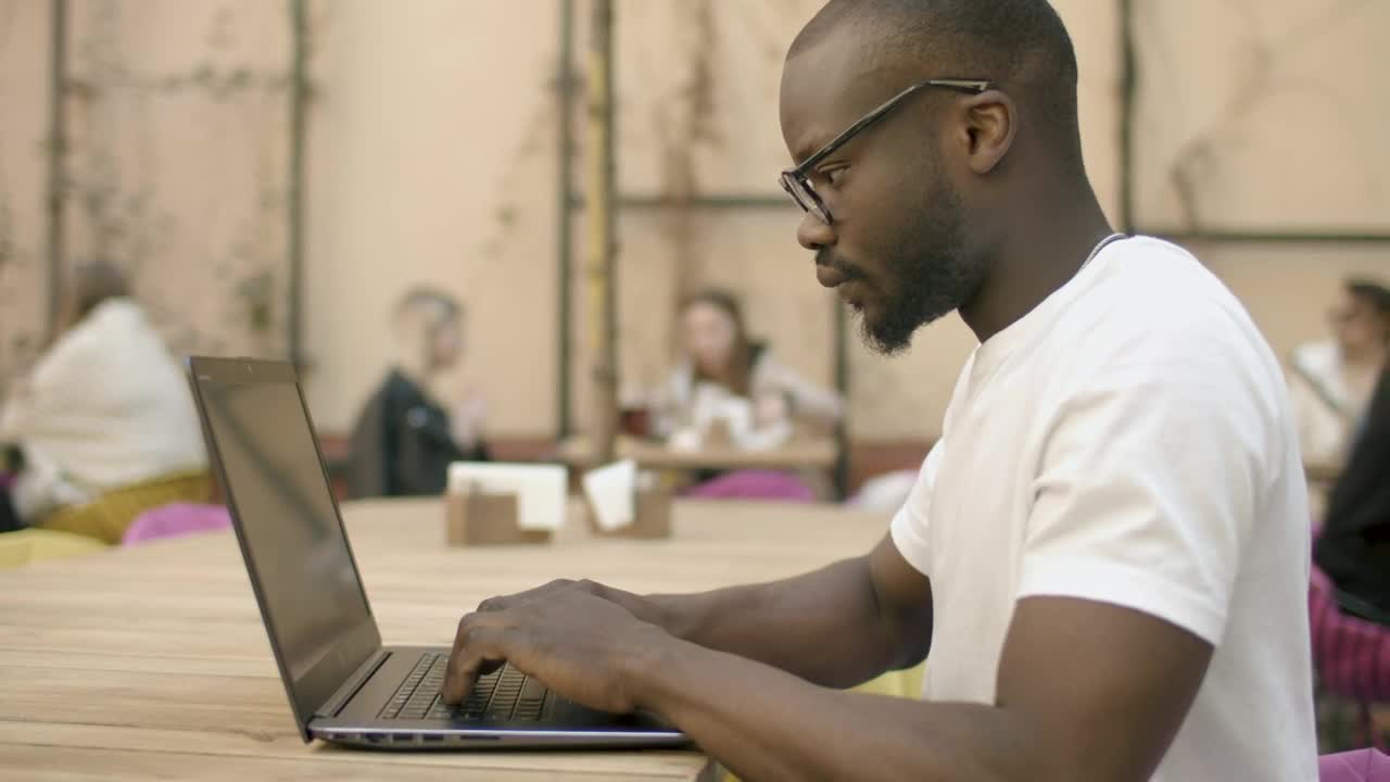 Stock Video Focused Man Types On Laptop In Outdoor Cafe Live Wallpaper For PC