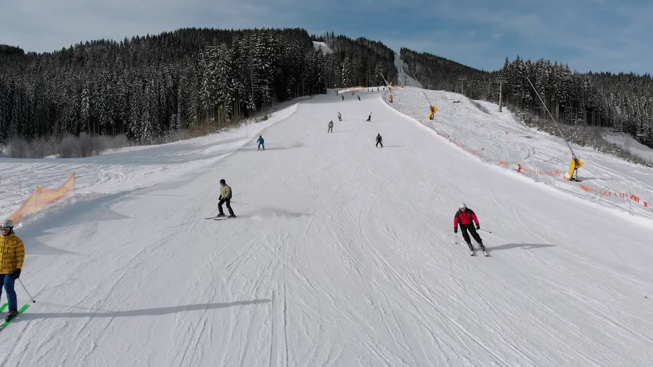 Stock Video Flying Over Skiers Going Down The Snowy Moountain Live Wallpaper For PC