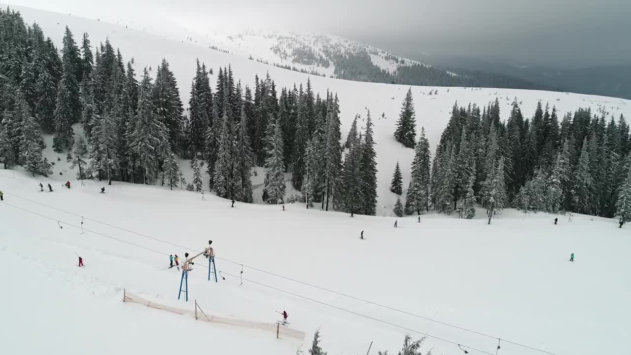 Stock Video Flying Over Mountains Slope With Skiers Live Wallpaper For PC