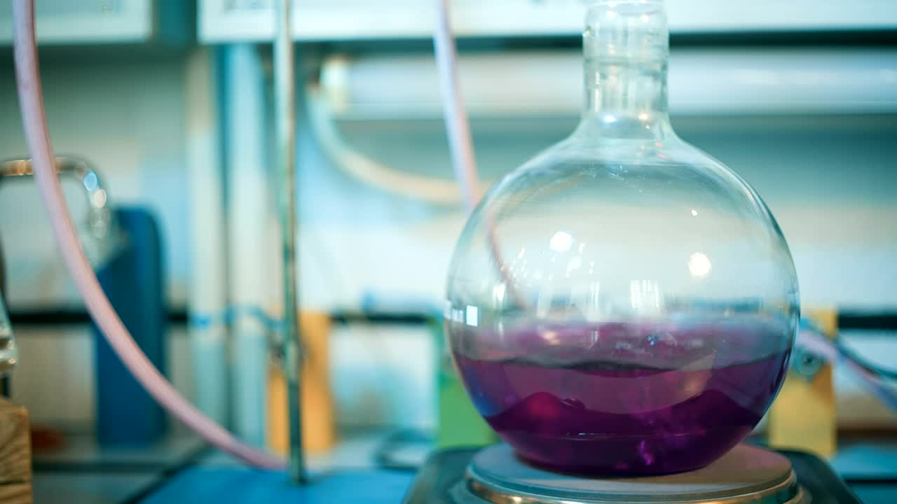 Stock Video Flask Of Boiling Purple Liquid In A Lab Live Wallpaper For PC