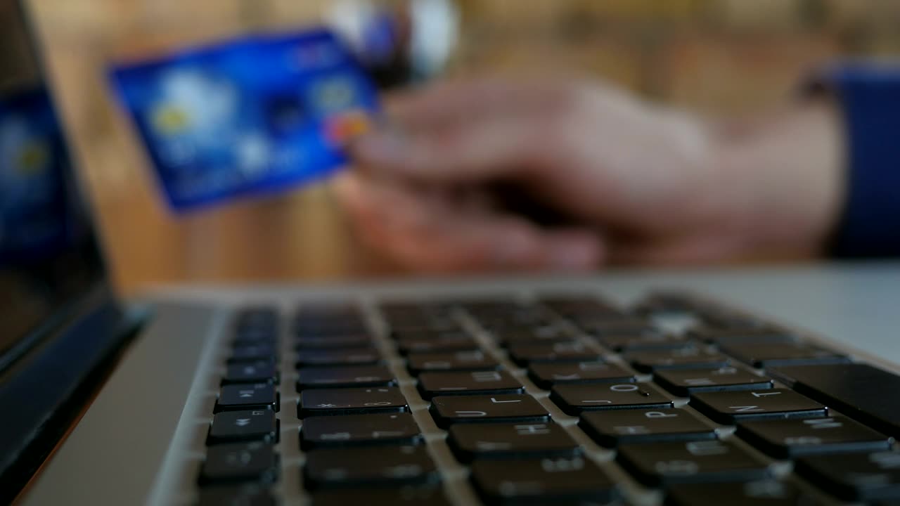 Stock Video Finger Typing And Unfocused Hand Holding Credit Card Live Wallpaper For PC