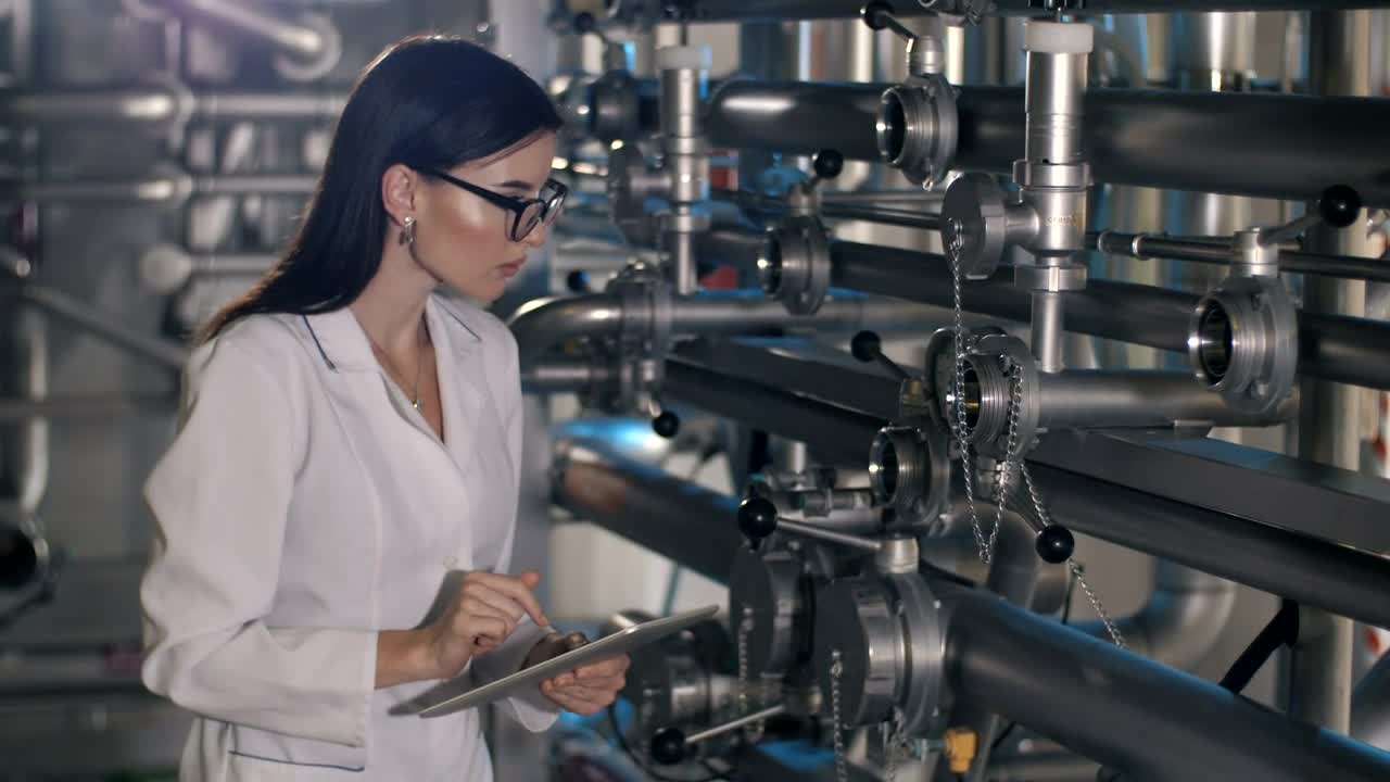 Stock Video Female Worker Checks Pressure Levels In Machines Live Wallpaper For PC