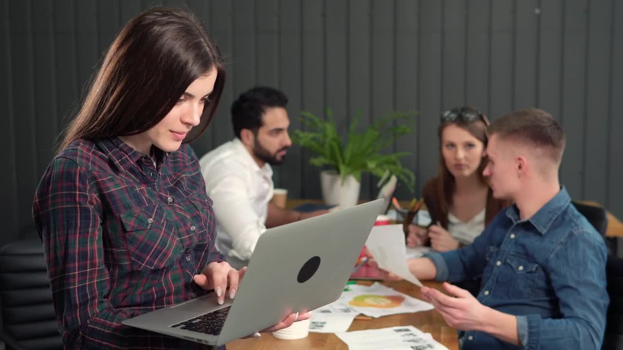Stock Video Female Team Leader Holding Laptop Turns And Smiles Live Wallpaper For PC
