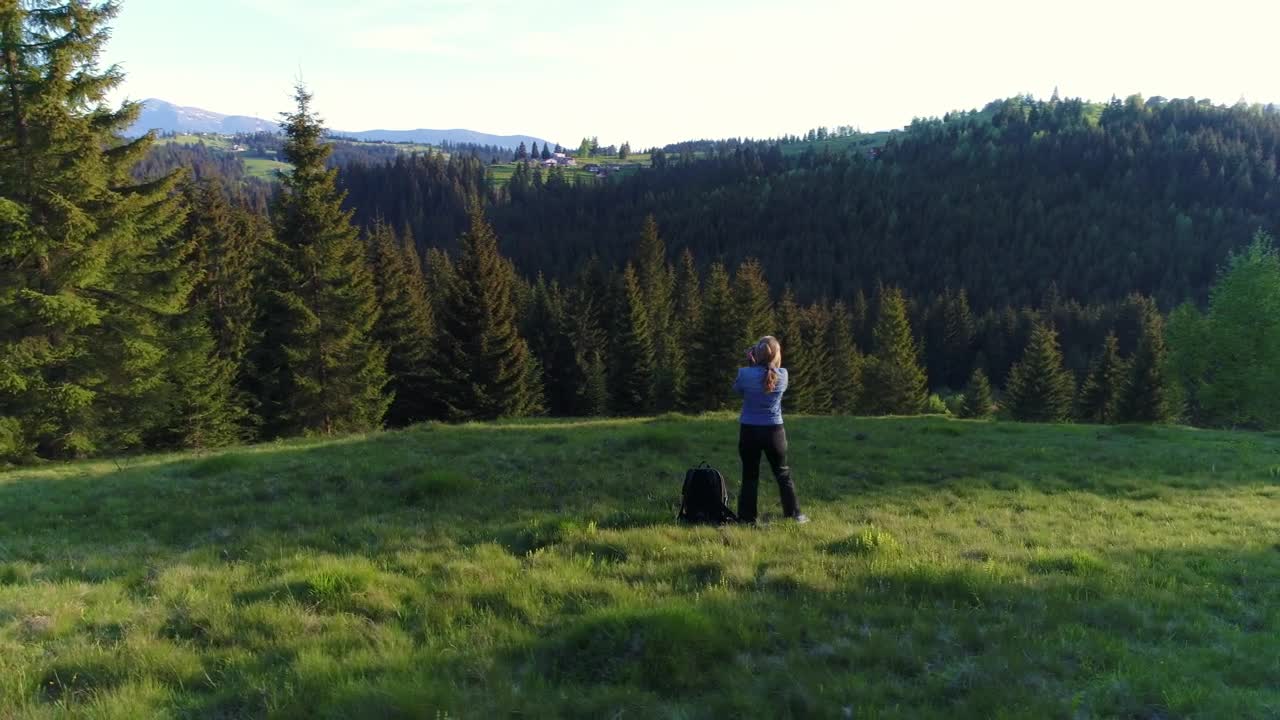 Stock Video Female Photographer Taking Pictures In A Forest Meadow Live Wallpaper For PC