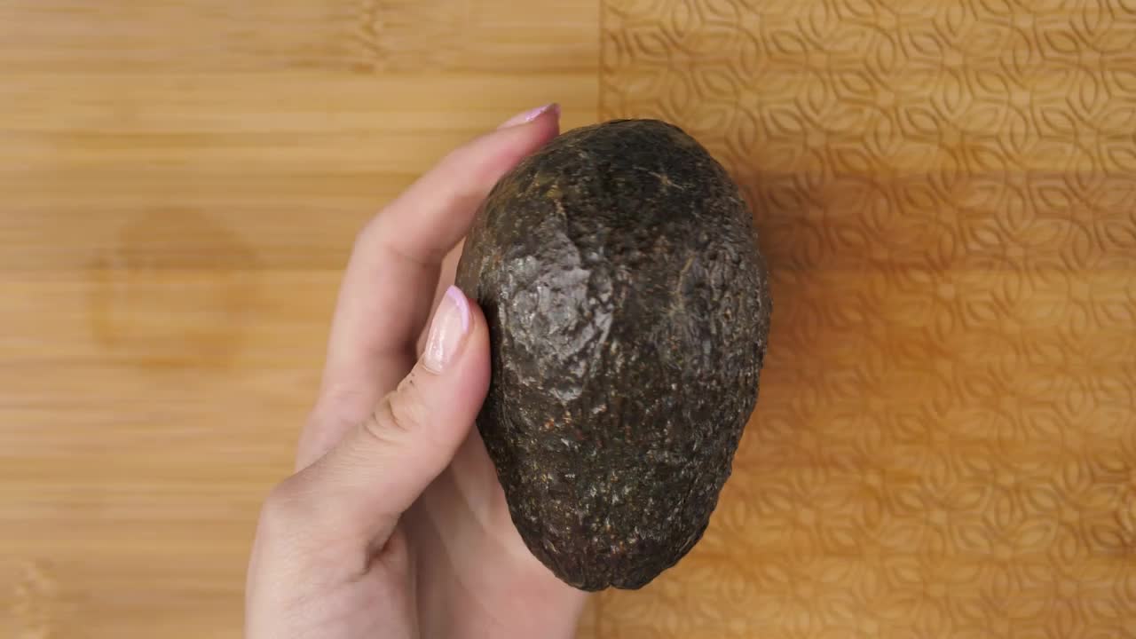 Stock Video Female Hands Cutting An Avocado In The Kitchen Live Wallpaper For PC
