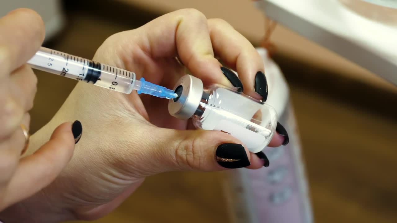 Stock Video Female Doctor Is Preparing An Injection Syringe Live Wallpaper For PC