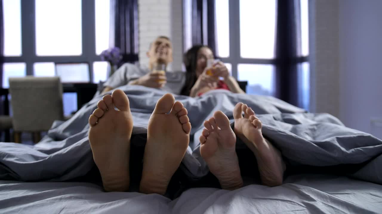 Stock Video Feet Of A Man And A Woman Lying On A Live Wallpaper For PC