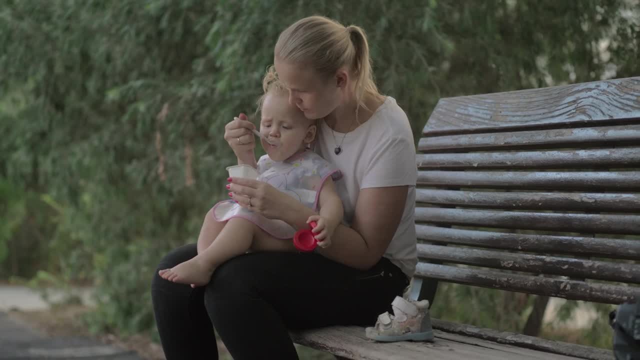 Stock Video Feeding Her Young Child A Yogurt Live Wallpaper For PC