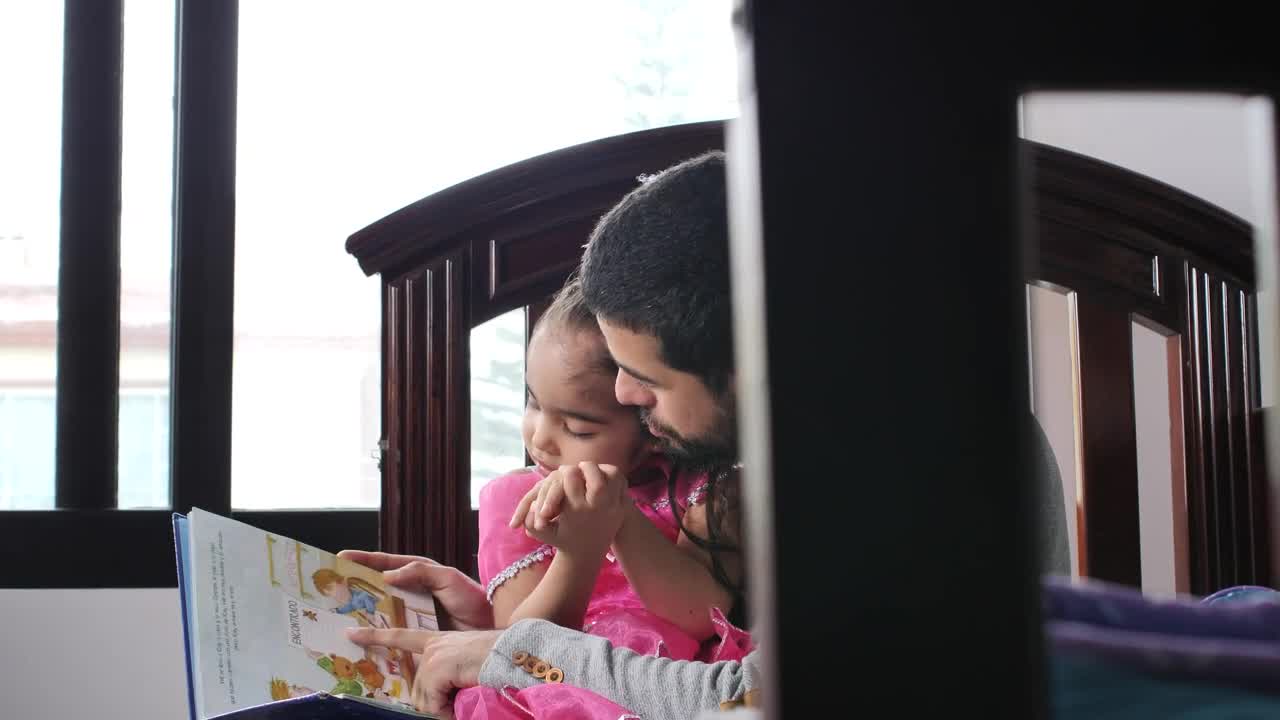 Stock Video Father With His Daughter In His Arms Reads A Childrens Live Wallpaper For PC