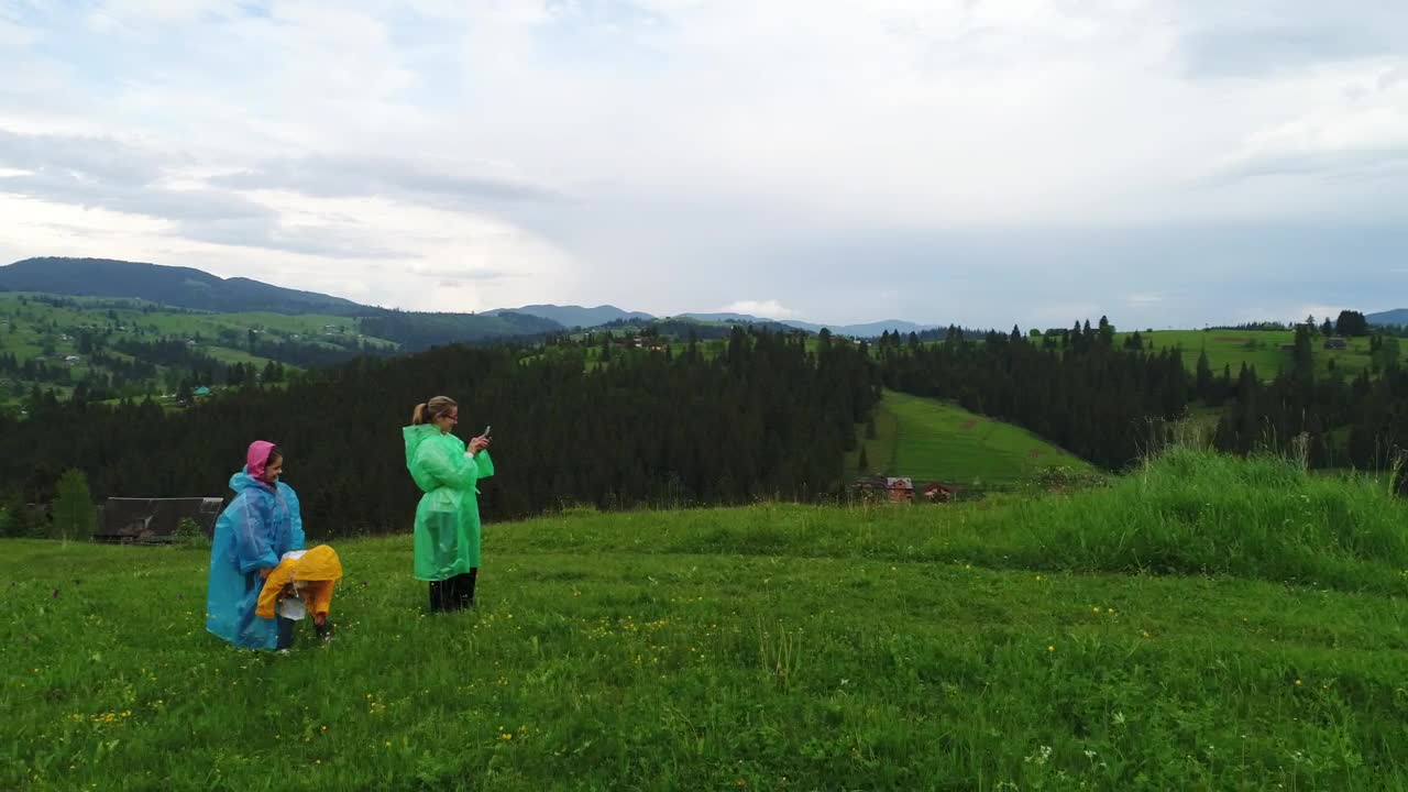 Stock Video Family Wearing Raincoats Taking Selfies In Nature Live Wallpaper For PC