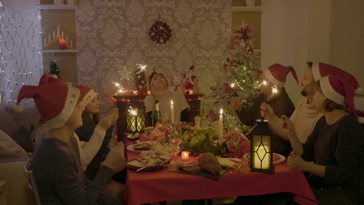 Stock Video Family Sings And Waves Sparklers At Holiday Dinner Live Wallpaper For PC