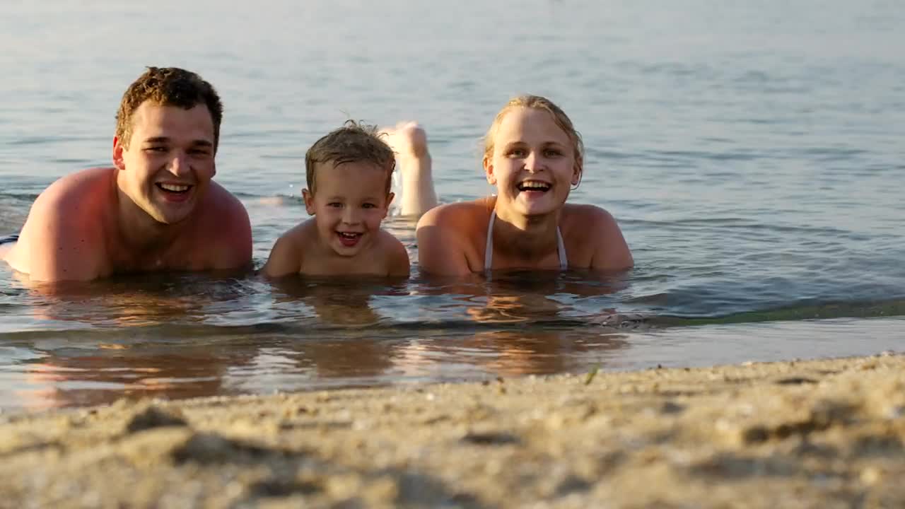 Stock Video Family Laughing While Laying In The Ocean Live Wallpaper For PC