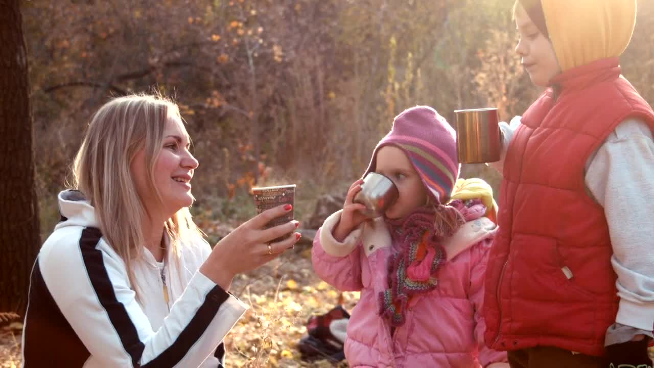 Stock Video Family Drinking A Hot Beverage In An Autumn Forest Live Wallpaper For PC