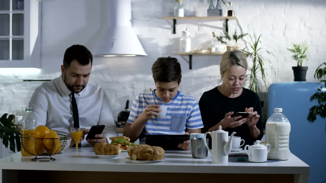 Stock Video Family At Breakfast Watching Their Smartphones Live Wallpaper For PC