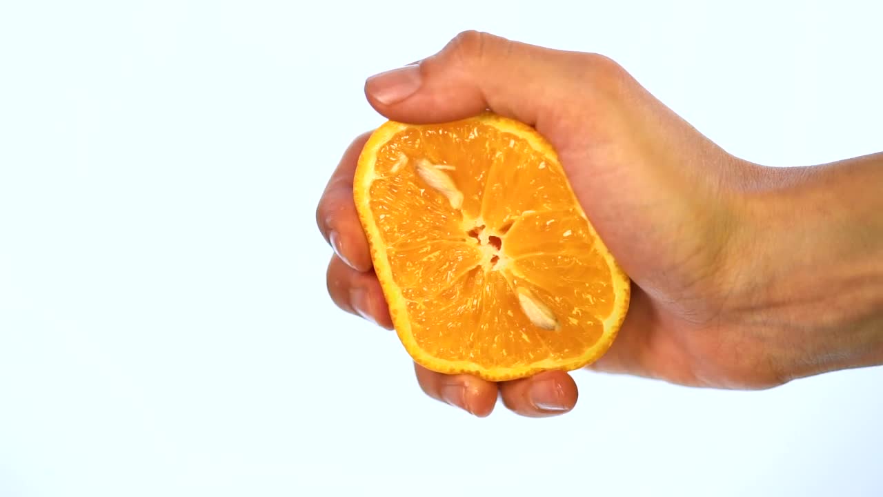Stock Video Hand Of A Person Squeezing An Orange On A Light Live Wallpaper For PC