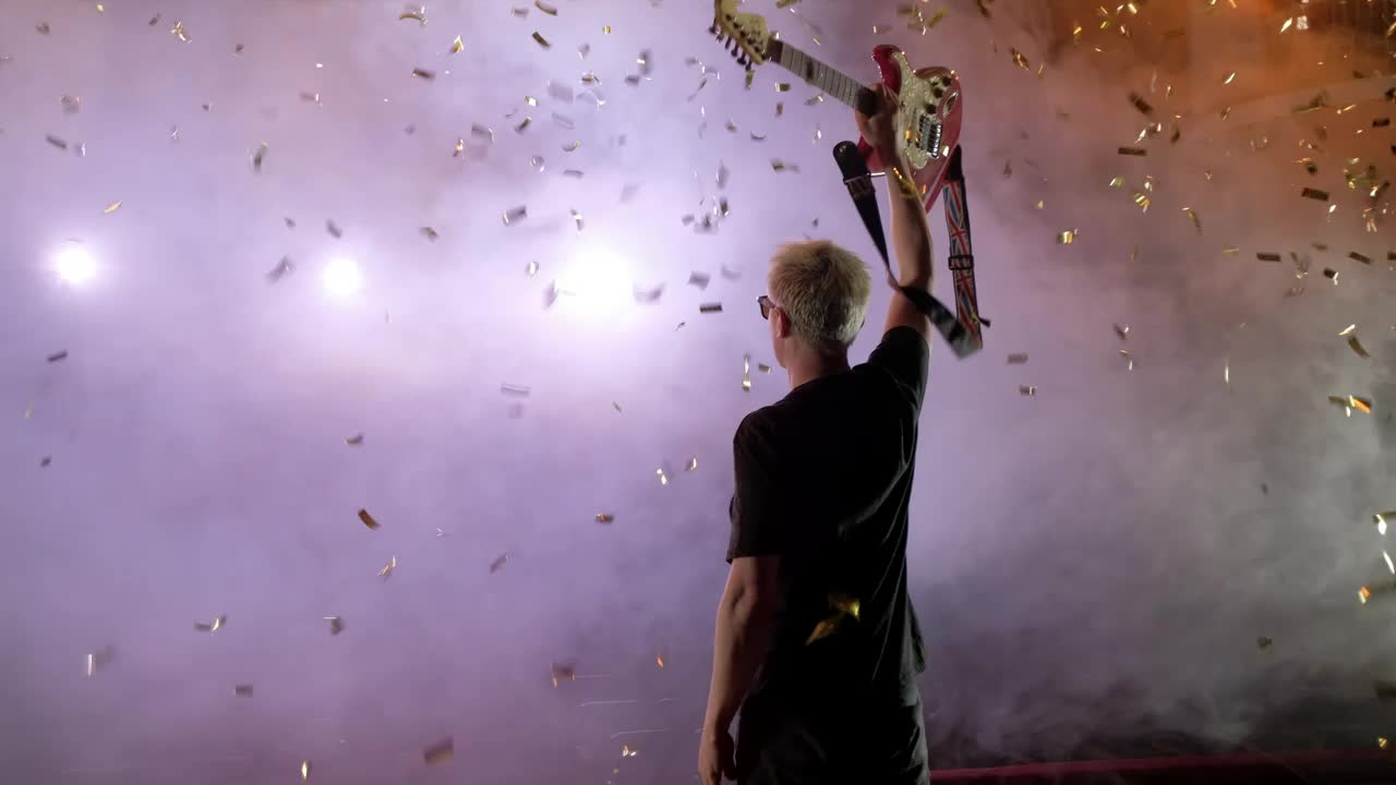 Stock Video Guitarist Raising His Guitar On A Smoky Stage Live Wallpaper For PC