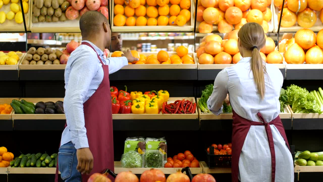 Stock Video Grocery Clerk Smelling Oranges Live Wallpaper For PC