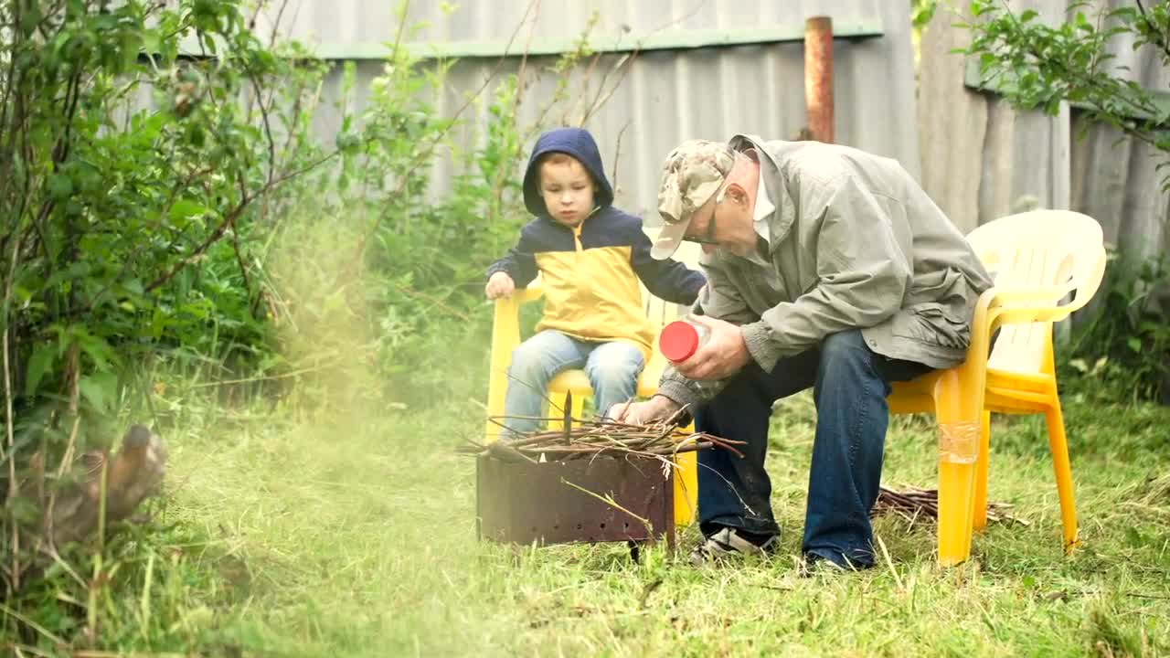 Stock Video Grandfather Preparing A Campfire Live Wallpaper For PC