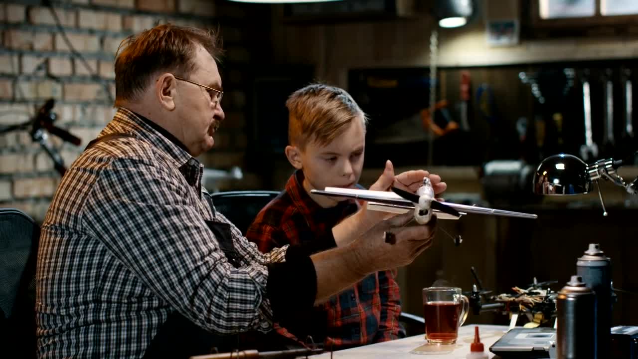 Stock Video Grandfather And Grandson Repairing A Toy Plane Live Wallpaper For PC
