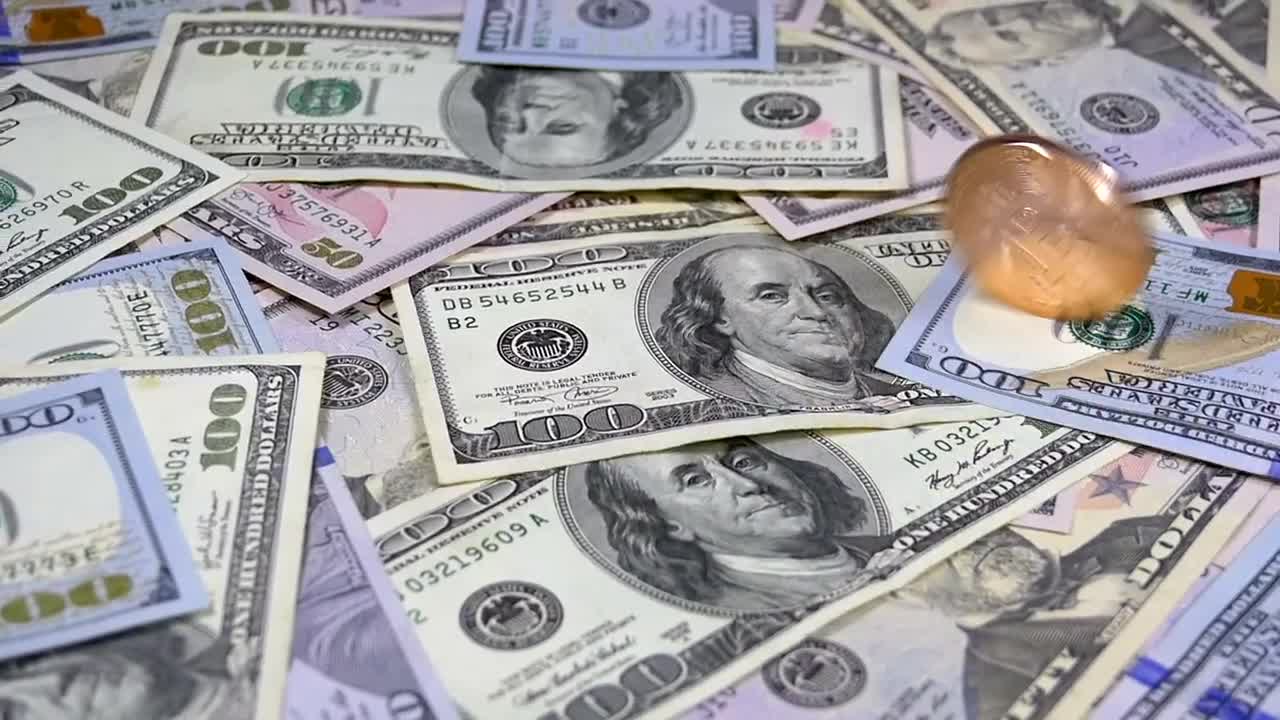 Stock Video Golden Bitcoin Rotating Over Dollar Bills Live Wallpaper For PC