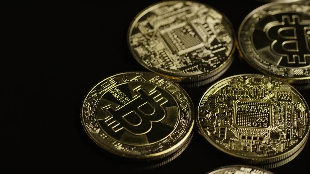 Stock Video Golden Bitcoin Coins Rotating On A Black Surface Live Wallpaper For PC