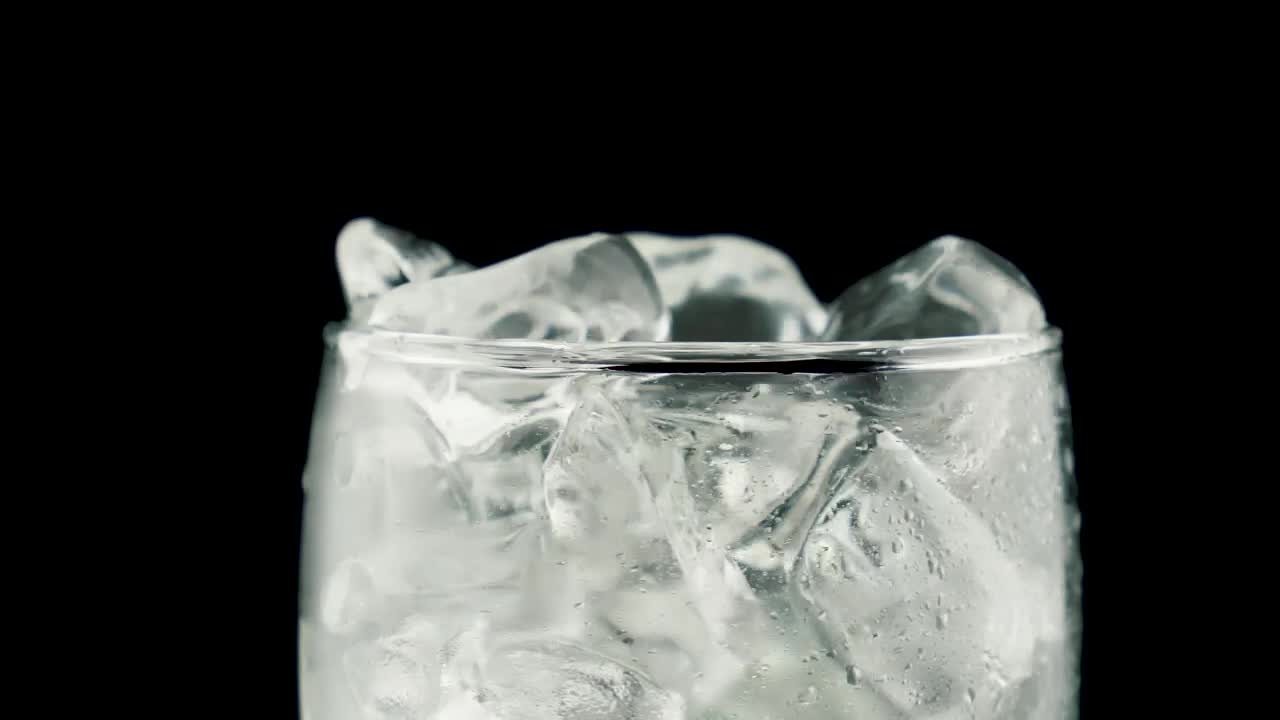 Stock Video Glass With Ice Filled With Soda On A Black Background Live Wallpaper For PC