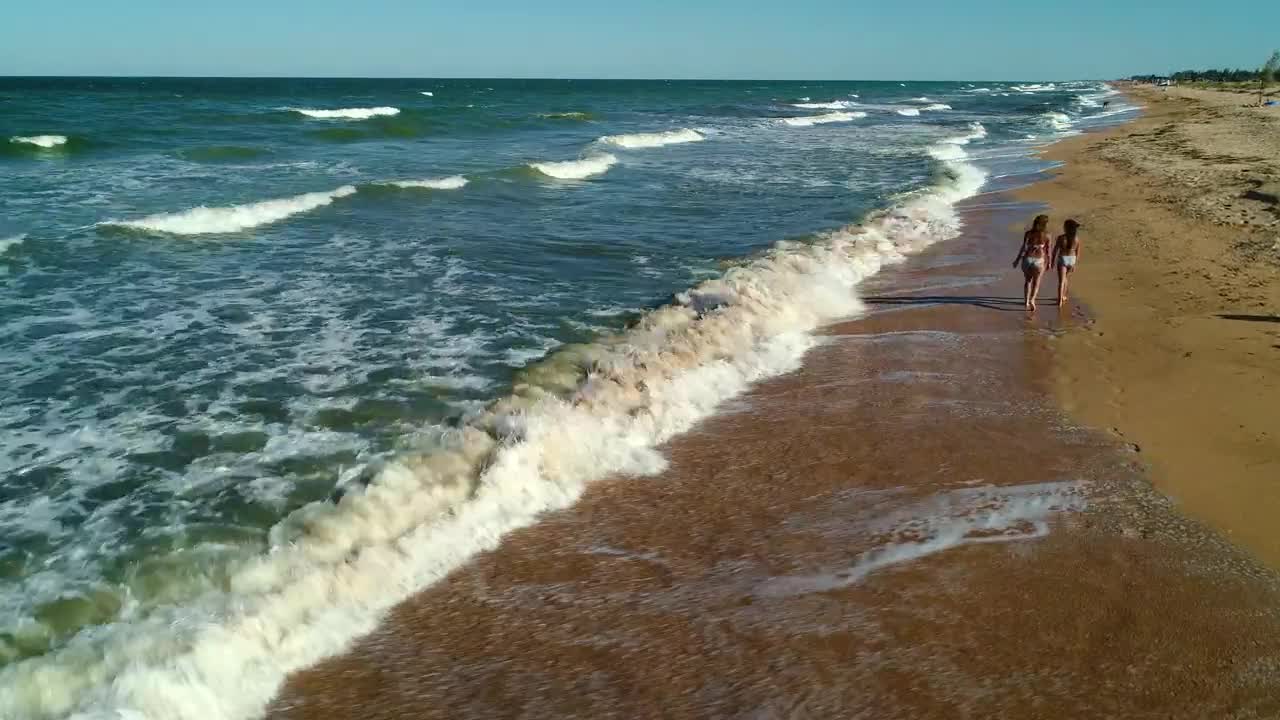 Stock Video Girls Walking On The Sand Next To The Sea Waves Live Wallpaper For PC