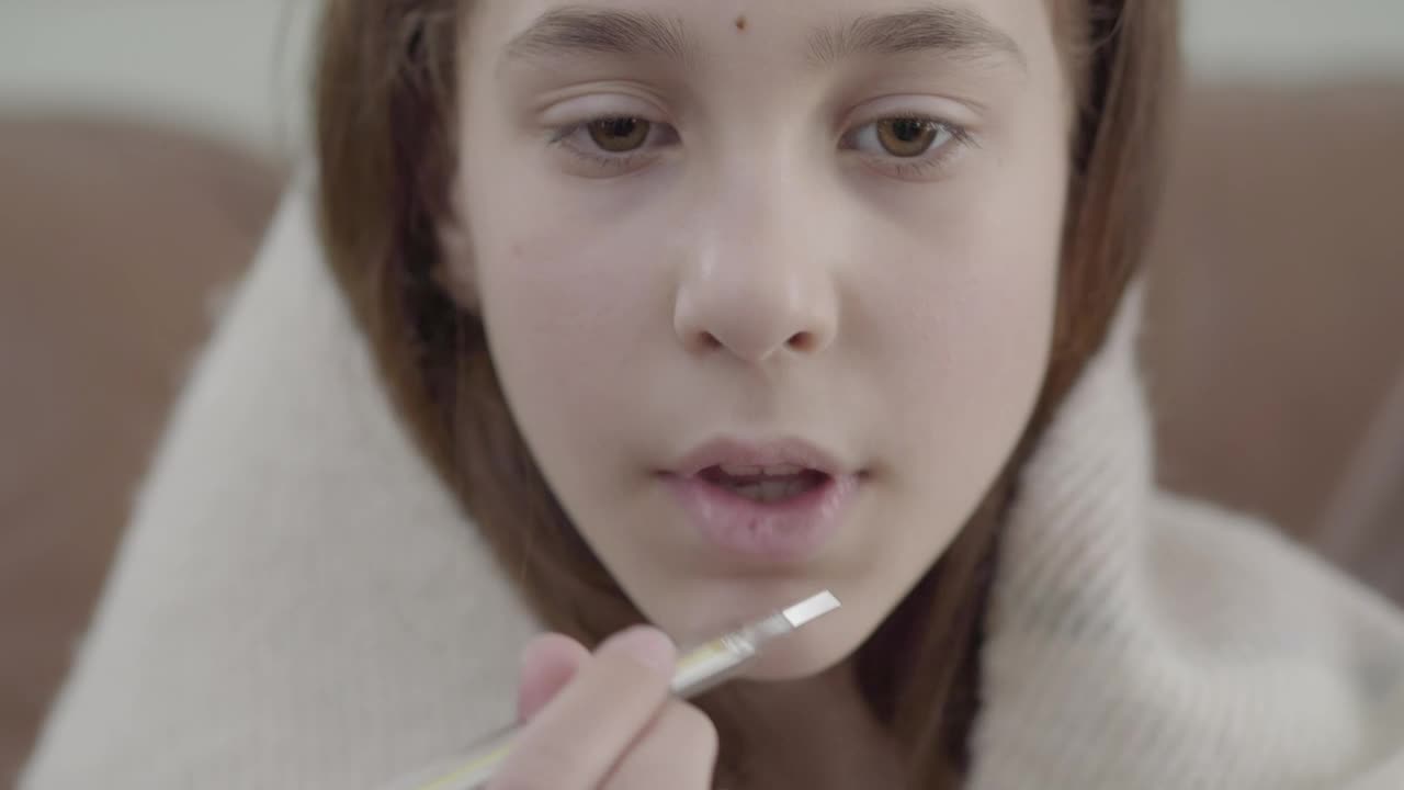 Stock Video Girl Wrapped In Blanket Puts Thermometer In Mouth Live Wallpaper For PC