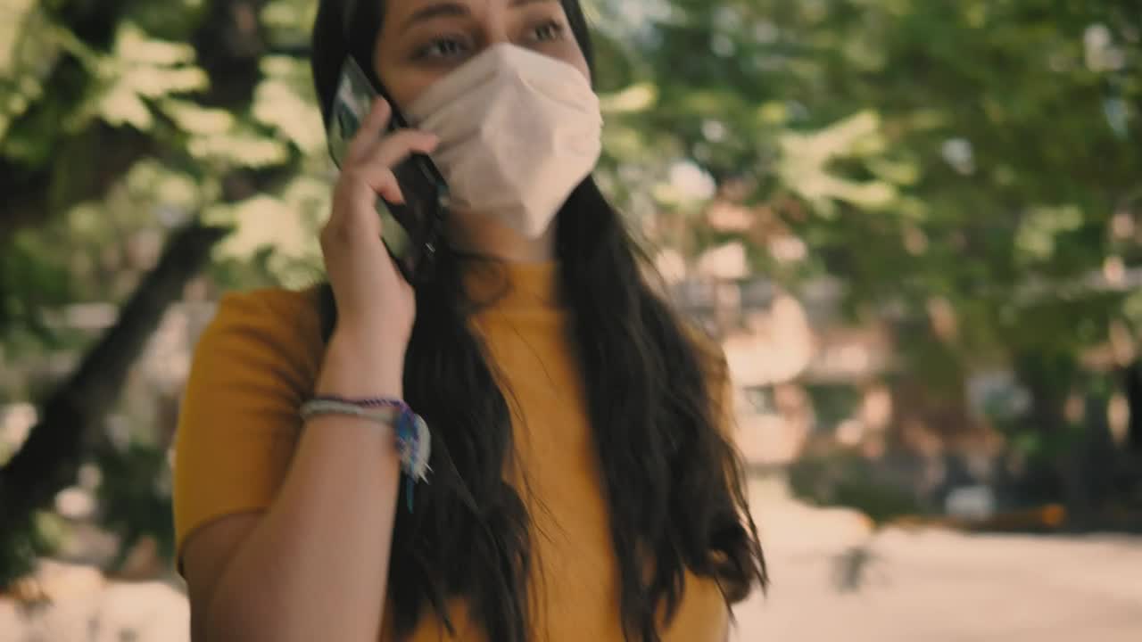Stock Video Girl With A Mask On The Street Answers A Call Live Wallpaper For PC
